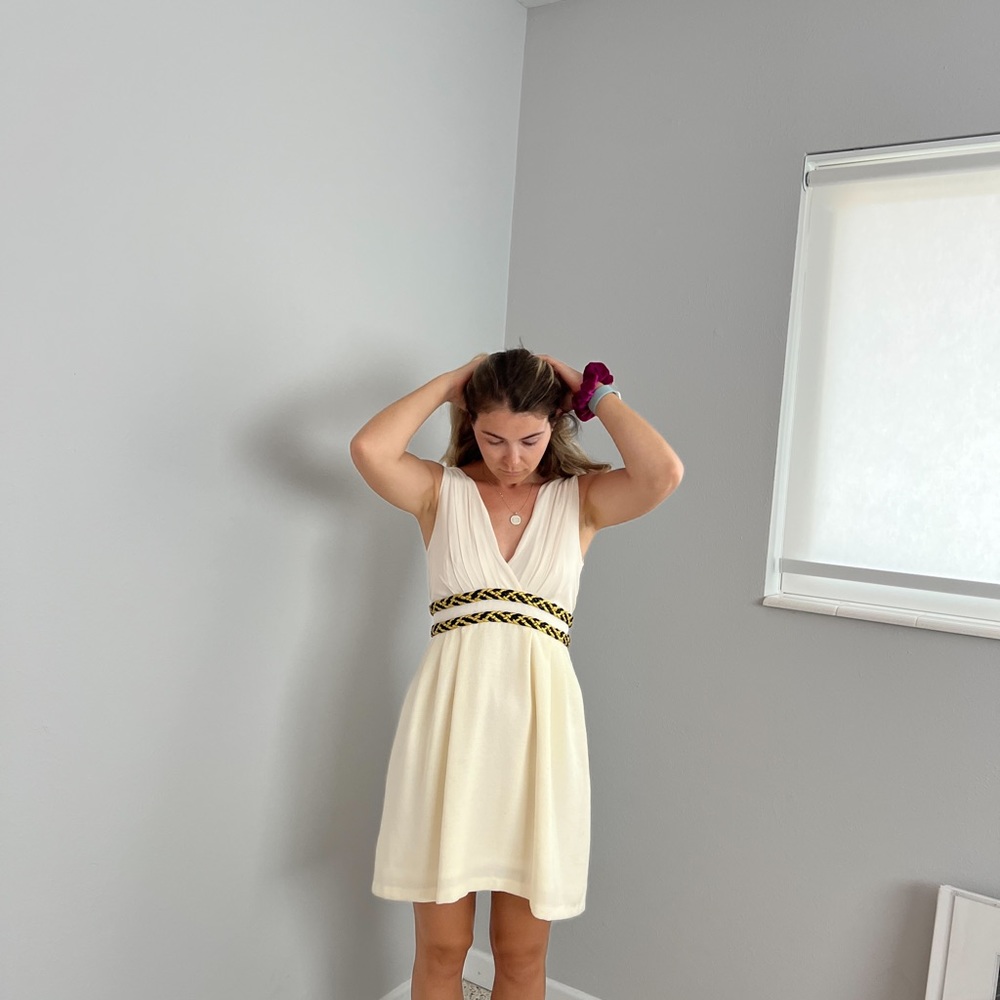 Formal white dress with deep V and attached gold and black belts